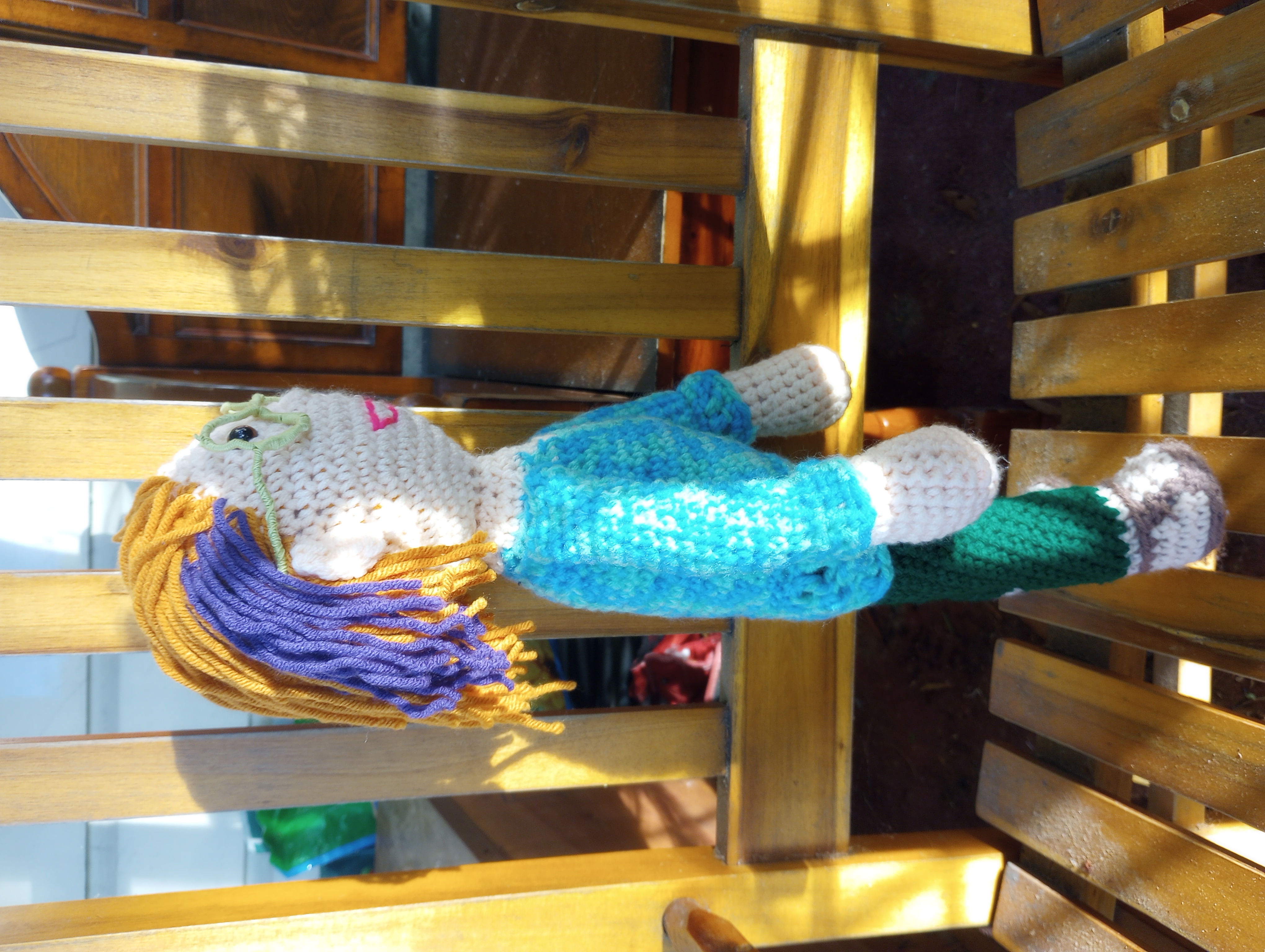 The same doll seen from the side, showing the purple streak more clearly