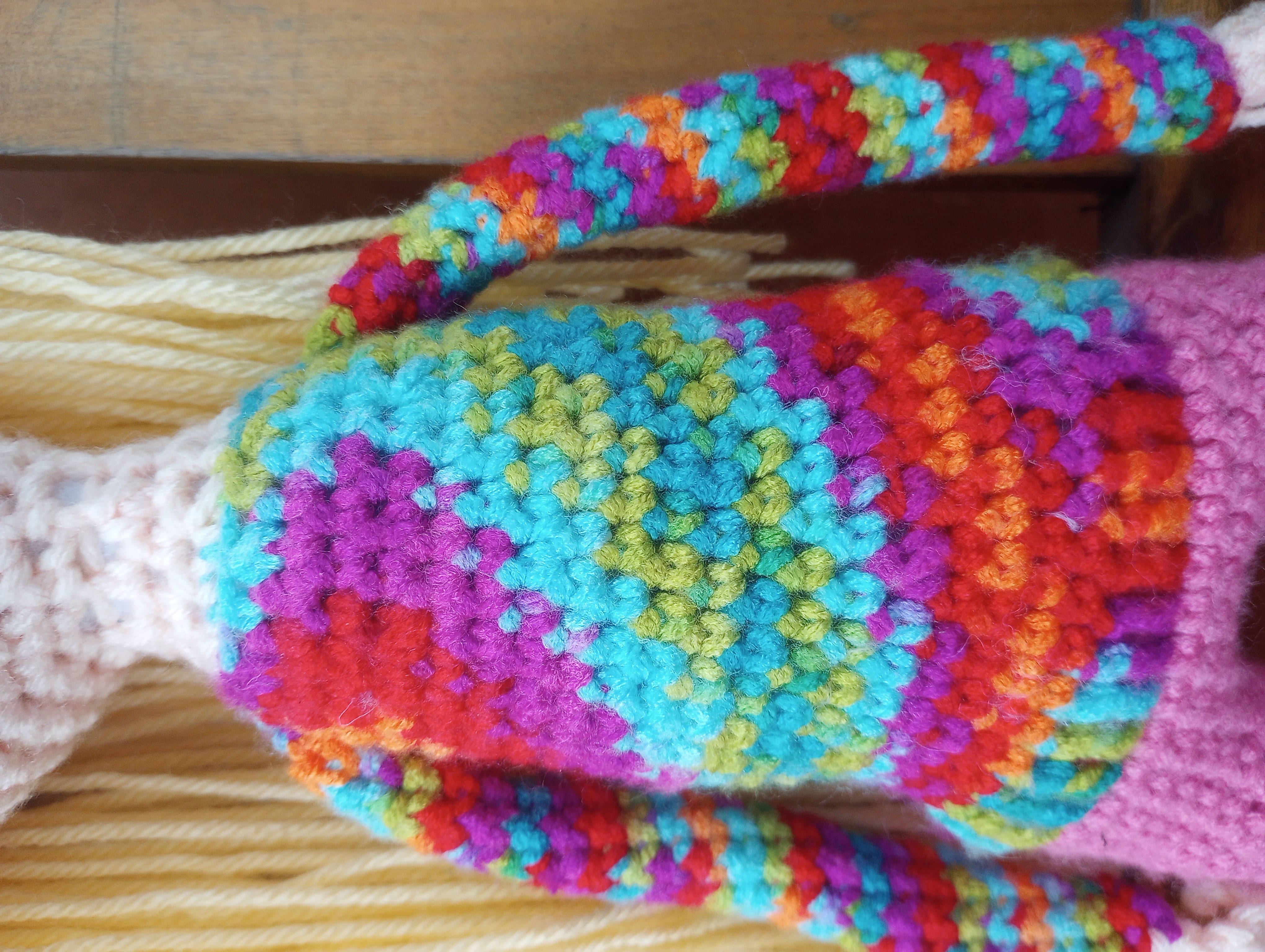 A close-up of the doll's torso, showing off the spiral effect of the yarn on its shirt.