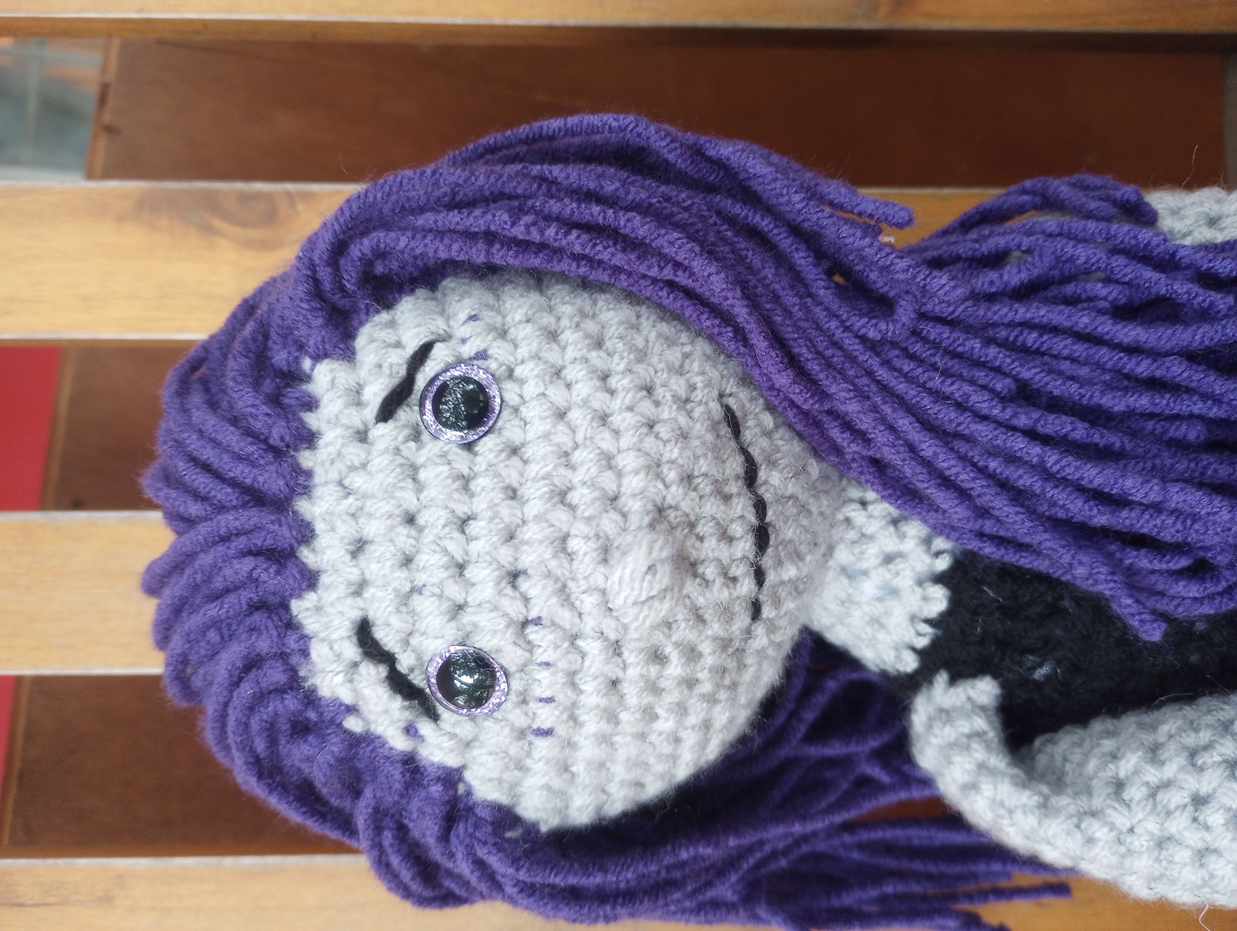 A close-up of the doll's face, displaying her worried eyebrows and awkward smile