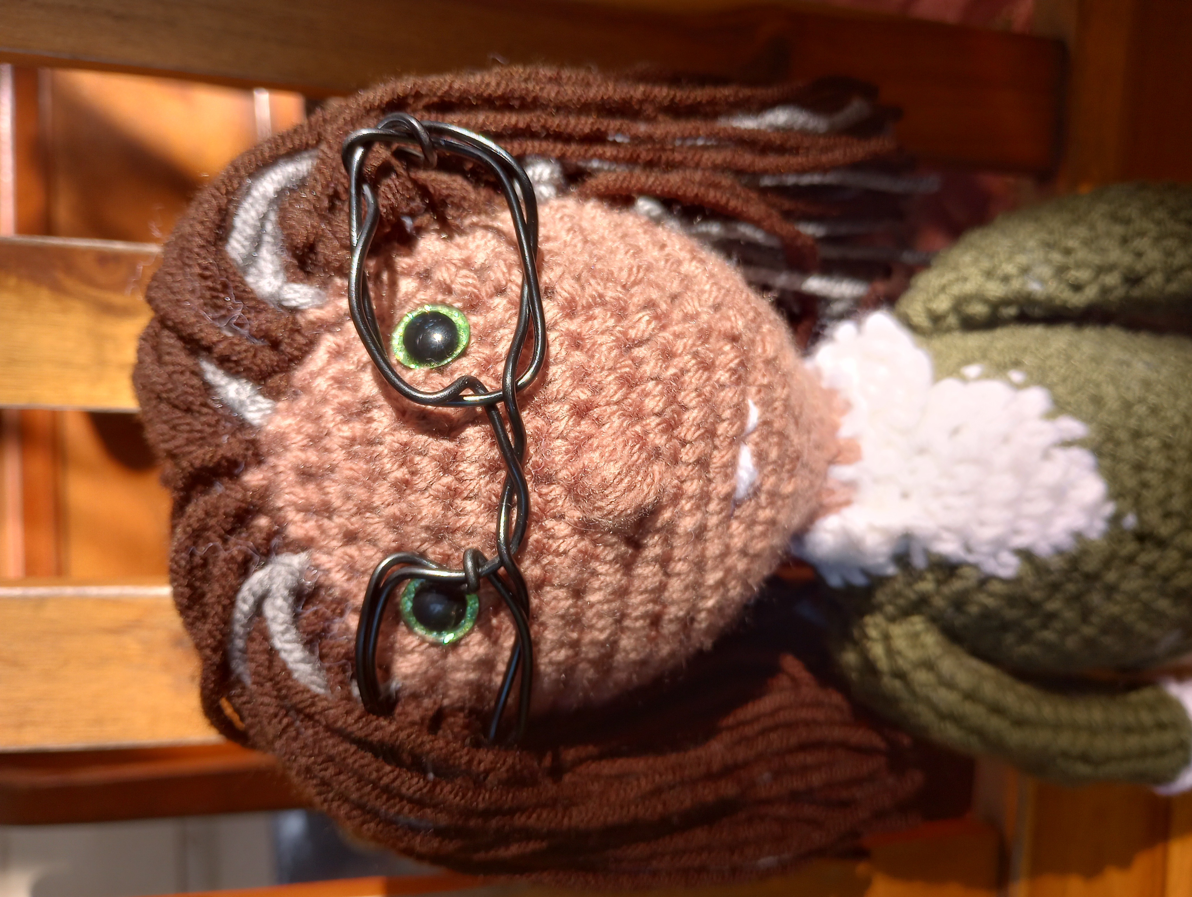 A close-up of the doll's face, showing his bright green eyes and slight buck teeth