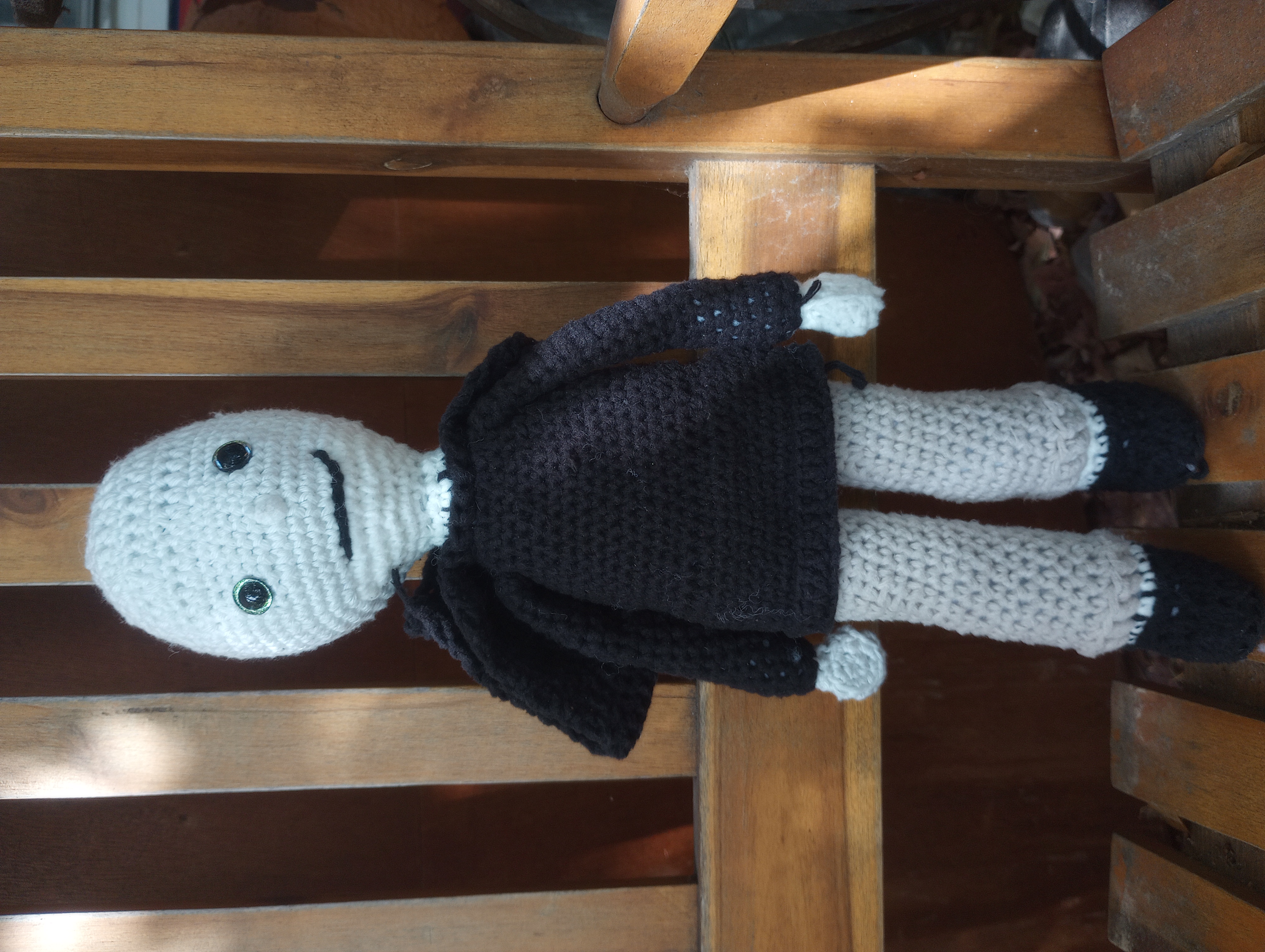 The same doll, now with the hood pulled down to show that he is completely bald
