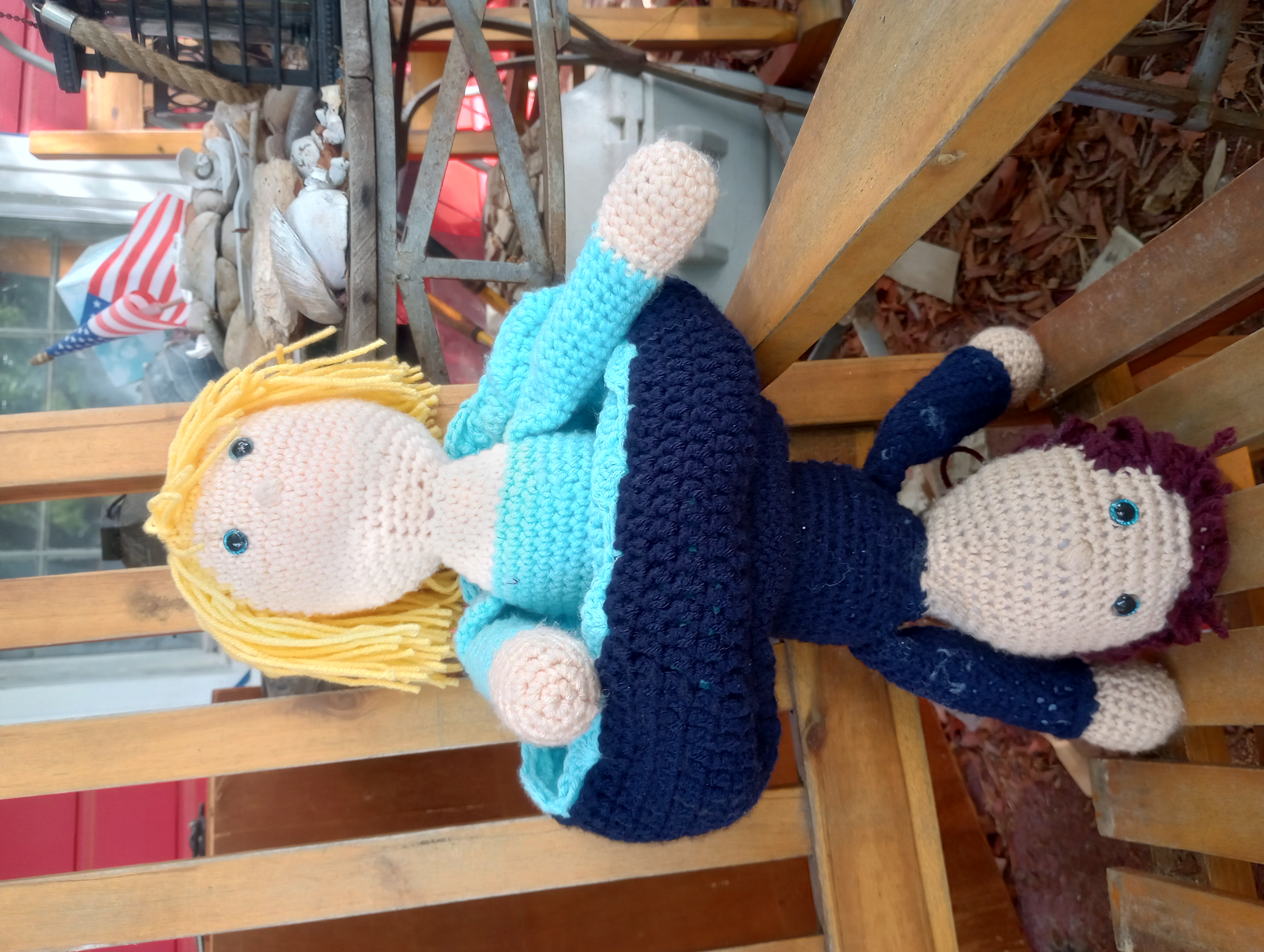 A single crocheted doll with the skirt rolled up to the middle, showing that the two dolls described above are actually one doll joined at the waist