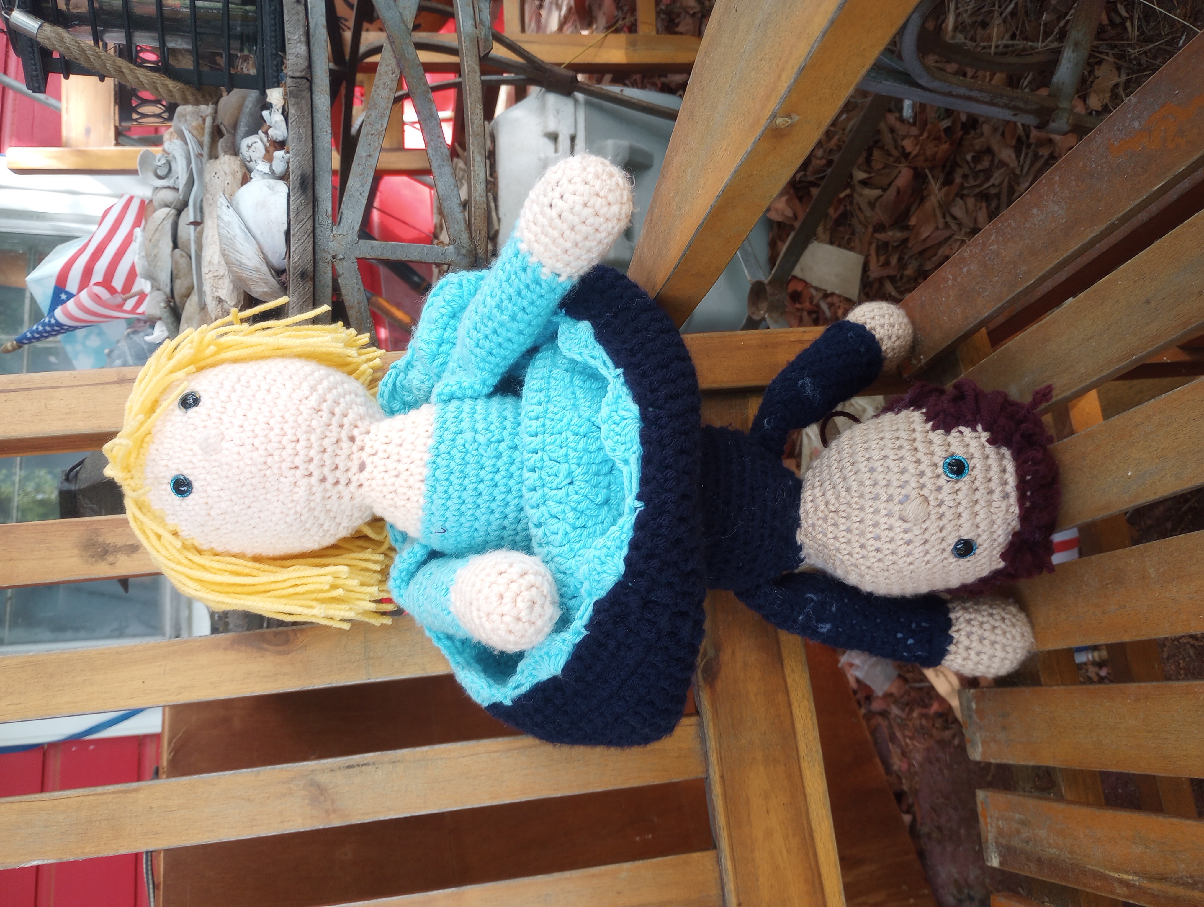 The same doll with the skirt rolled up, but folded down slightly to show part of the turquoise skirt