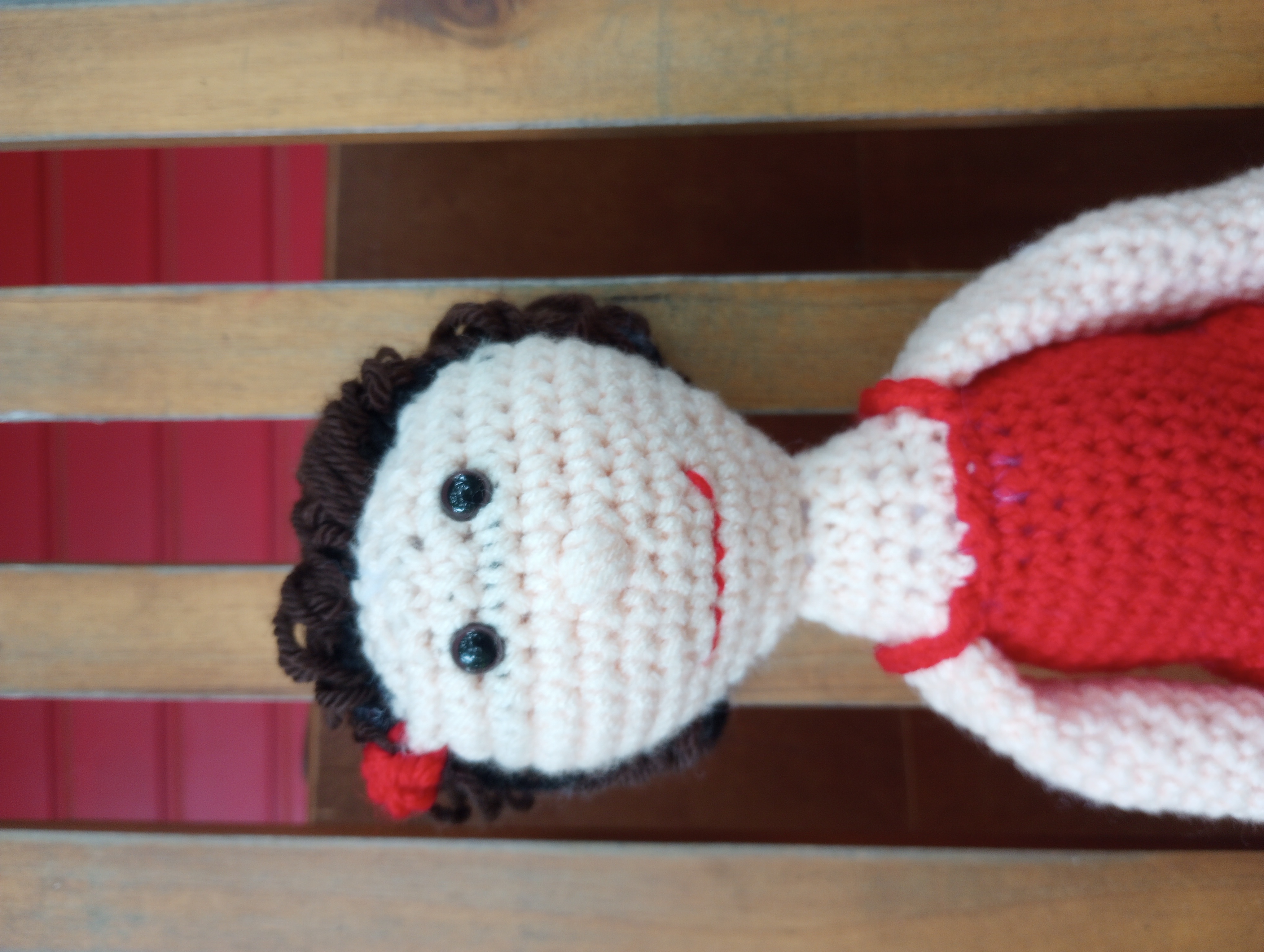 A close-up of the doll's face, showing her awkward smile