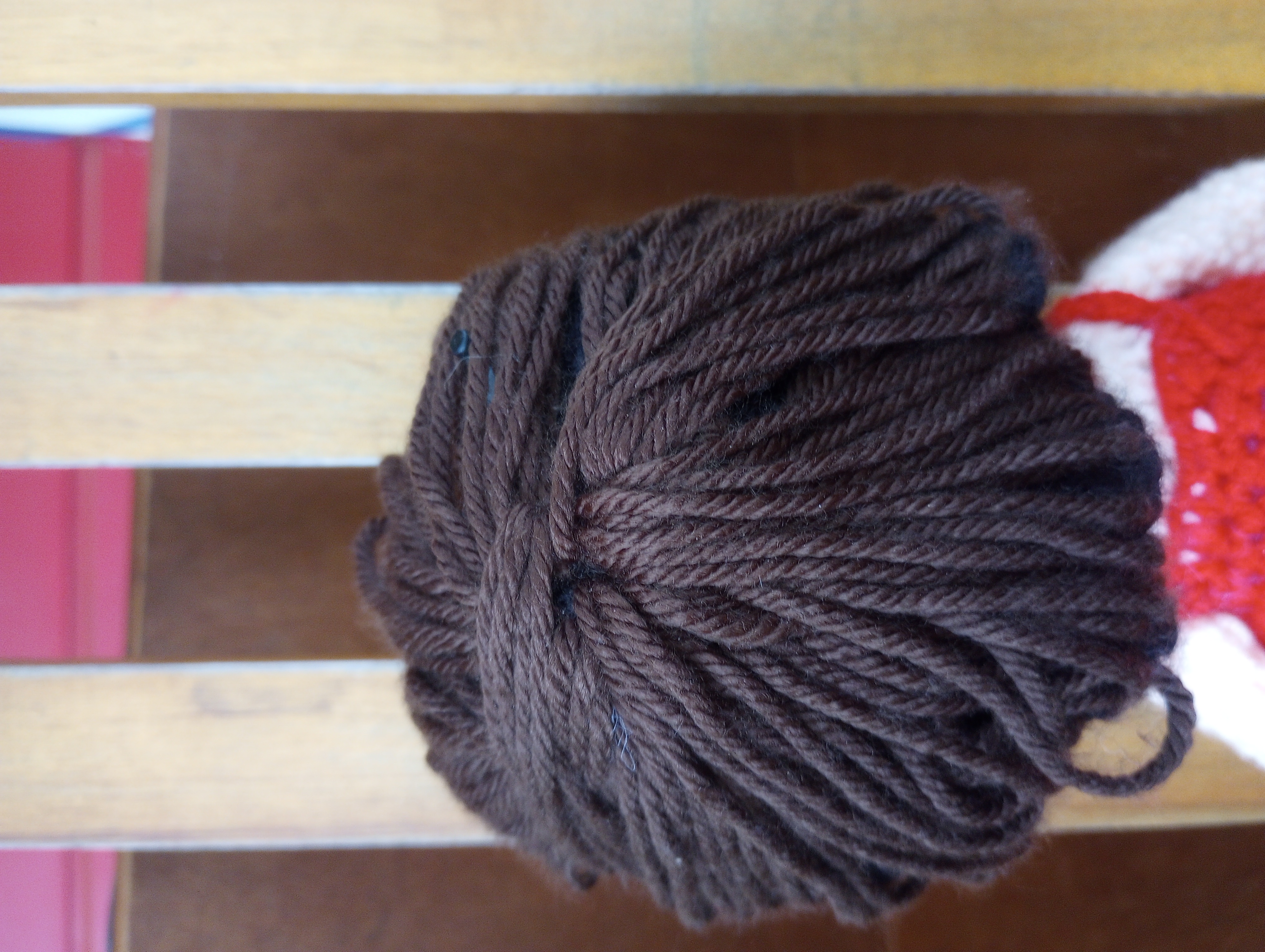 A close-up of the back of the doll's head, showing the hair twisted into a kind of knot