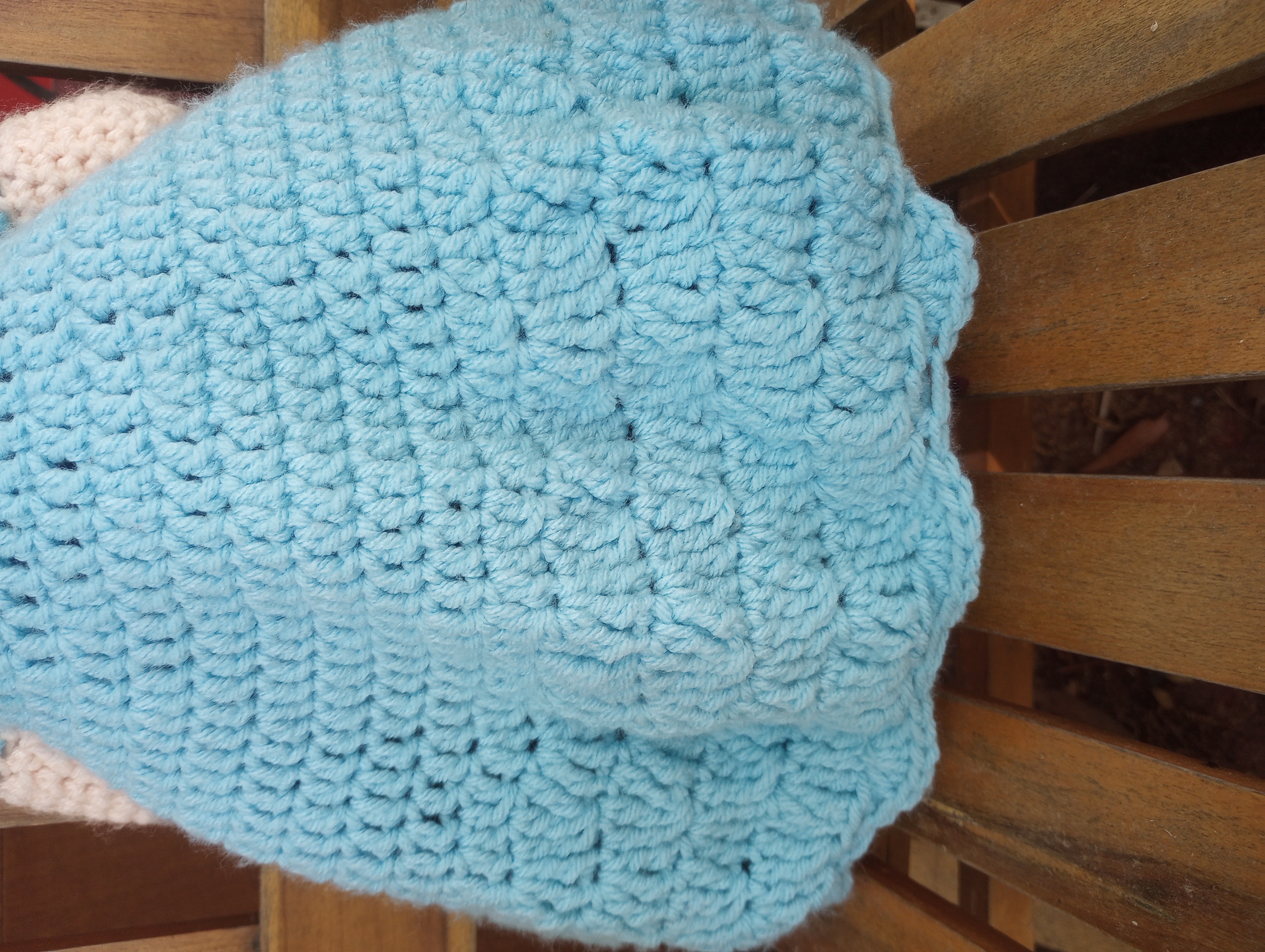 A close-up of the aqua skirt, showing a pattern of stitches that forms a series of raised diamonds at the bottom