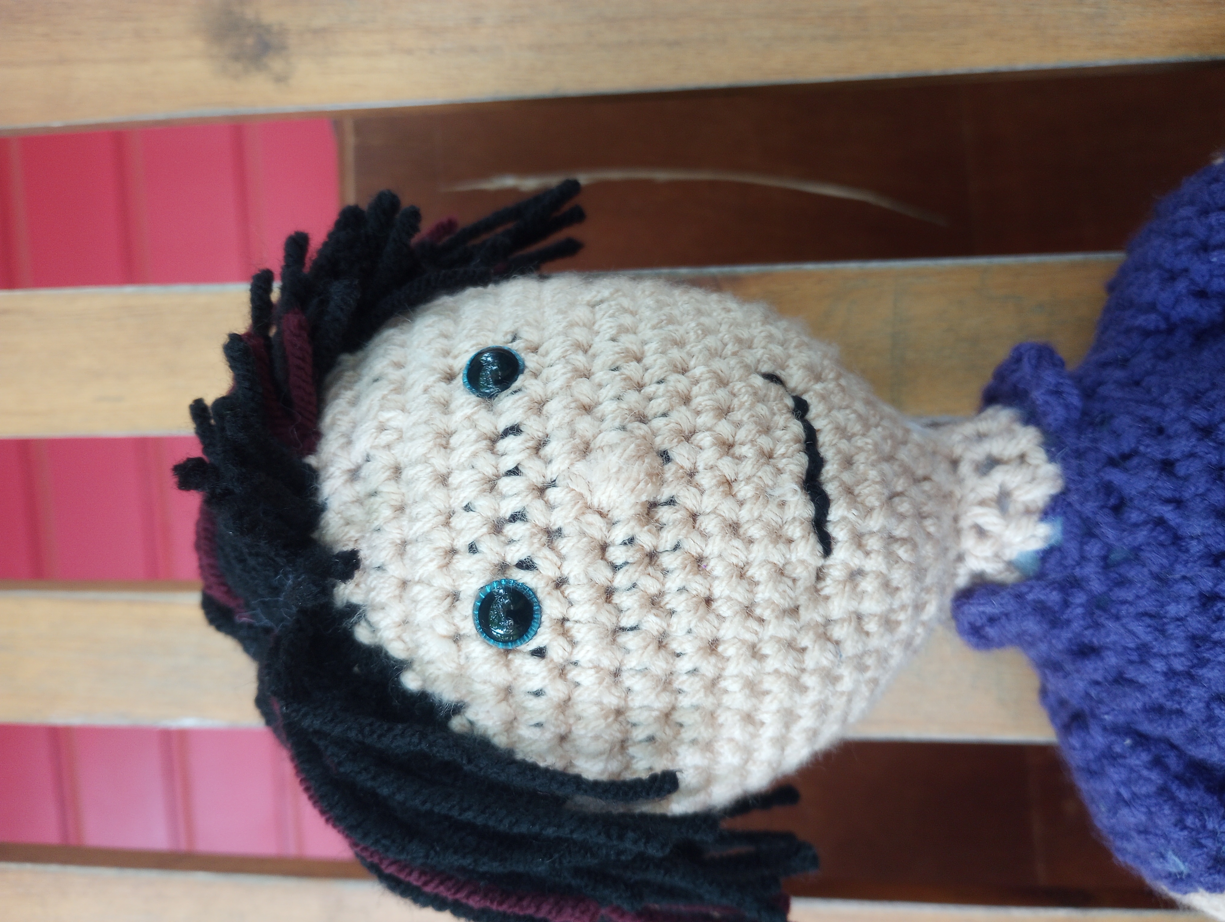 A close-up of the doll's face, highlighting his eyes and smile