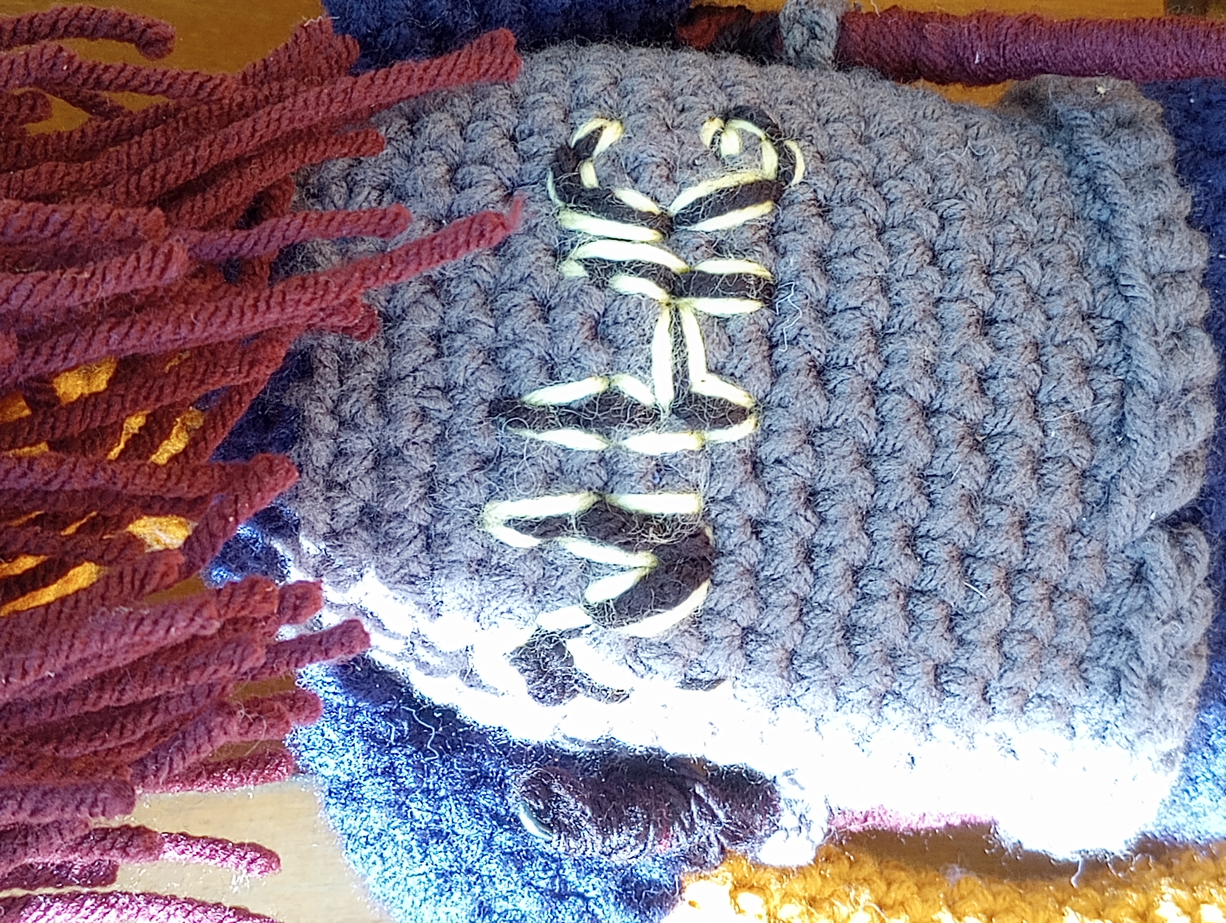 A close-up of the back of Zongroff's armor, showing the letters NHG stitched across the back