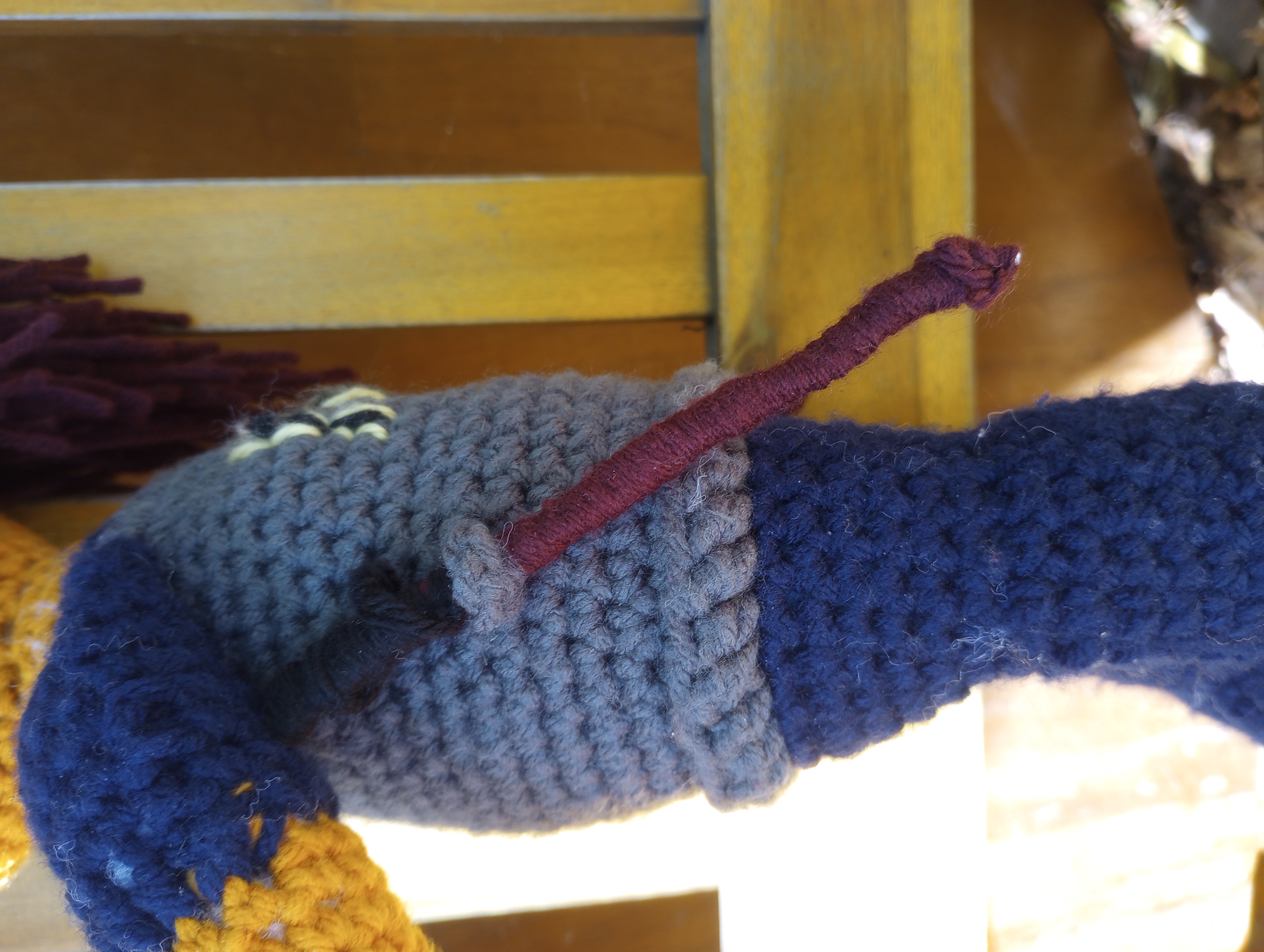 A close-up of one of Zongroff's sticks, a long narrow brown stick with a black grip, slung through a side holster